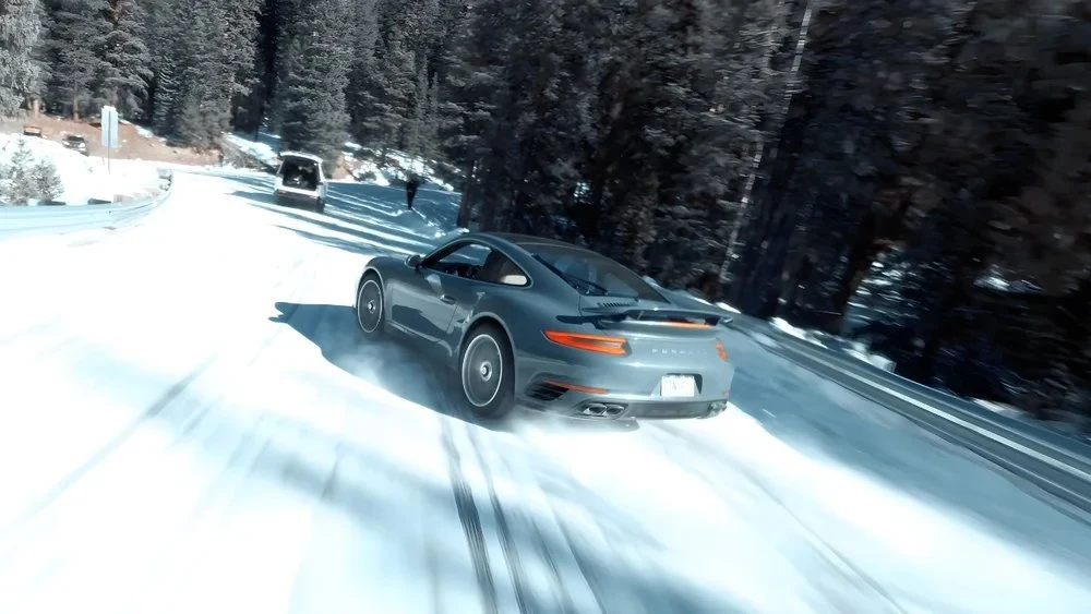 Porsche drifting on a snowy road